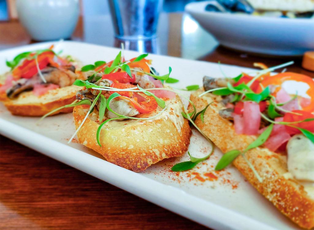 Smoked oysters with hummus, peppers, pickled onions and cilantro sprouts at William Tell House in Tomales, Claifornia. Heather Irwin/PD