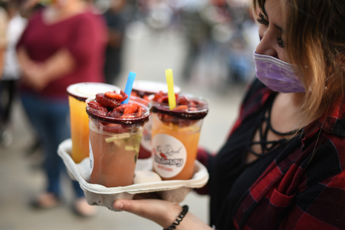 Jackalin Casillas with a few drinks from The Real Chamoy at The SoCo Market held in Old Courthouse Square in downtown Santa Rosa. (Erik Castro/for The Press Democrat)