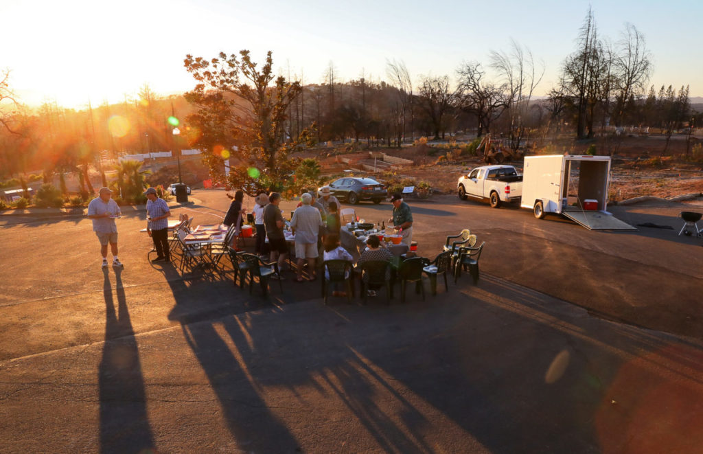 Neighbors on Bristlecone Court, in the Fountaingrove area of Santa Rosa, get together in their cul-de-sac to mark the anniversary of the Tubbs fire on Monday, October 8, 2018. (Christopher Chung/ The Press Democrat)