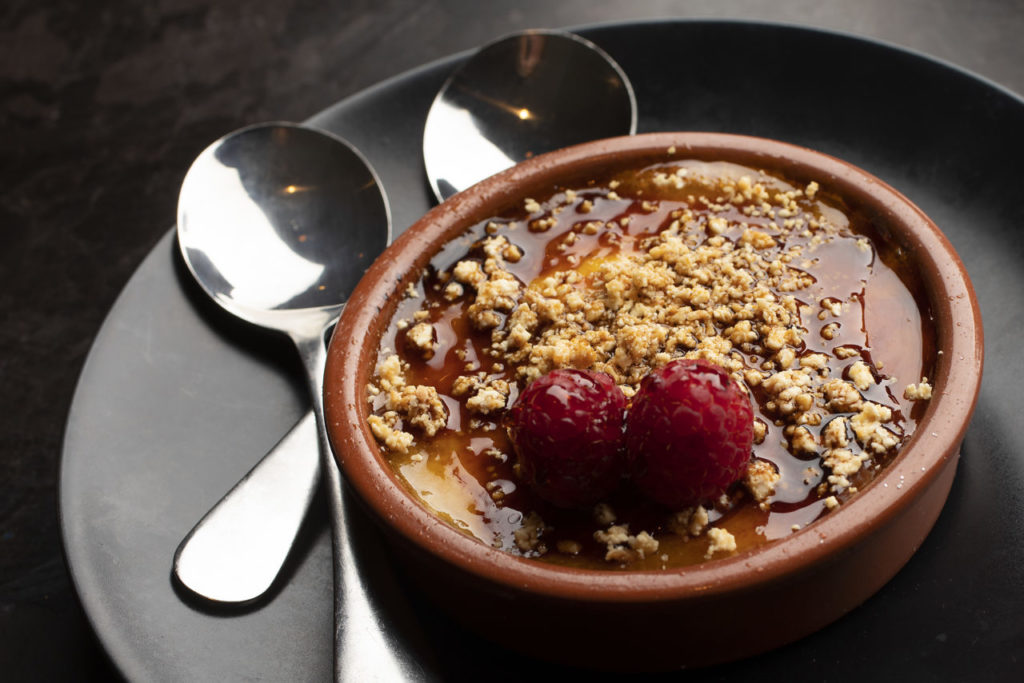 Creme Catalan with raspberry sauce from Gerard's Paella Y Tapas in downtown Santa Rosa. (photo by John Burgess/The Press Democrat)