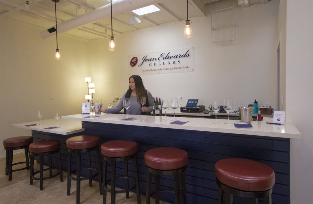 Jessica Saldana, tasting room manager at Jean Edwards Cellars in the Sonoma Court Shops (otherwise known as Vine Alley), prepares to received wine tasters on Sunday afternoon. (Photo by Robbi Pengelly/Index-Tribune)