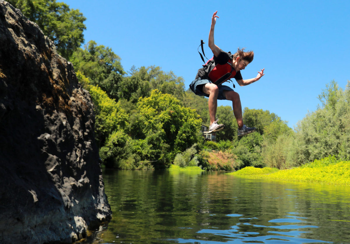 Hunter Gambill, 14, jumps into the Russian River on a lunch break while paddling 21 miles to Healdsburg with the LandPaths Russian River Teen Trek. (photo by John Burgess/The Press Democrat)