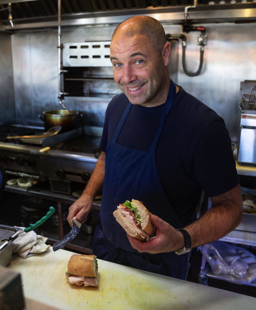 Fancy Fast Food Zoftig owner Matt Spector making sandwiches
