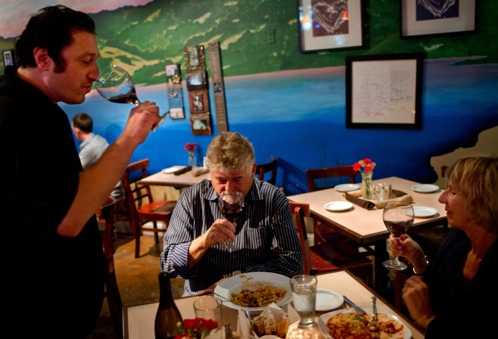 9/29/2013: D1: PC: Riccardo Cattaneo, left, tastes Barbed Oak Vineyard wine brought in by vineyard owners Ed and Barbara Pascoe, at Trattoria Cattaneo, in Santa Rosa, Calif., on September 24, 2013. (Alvin Jornada / The Press Democrat)