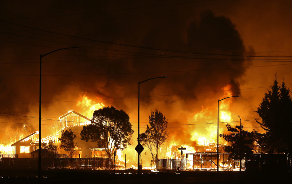 A neighborhood Wikiup area is engulfed in flames in Santa Rosa early Monday morning, October 9, 2017. (Christopher Chung/ The Press Democrat)
