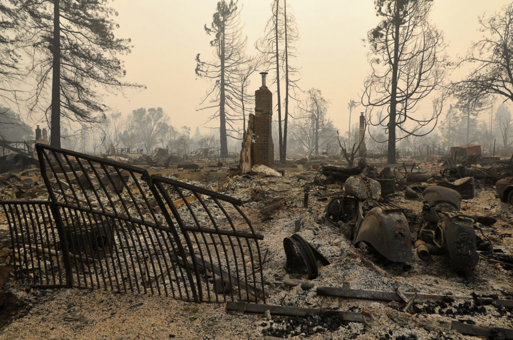 A pair of motorcycles and a melted gate along Brighton Court, in the Larkfield-Wikiup area of Santa Rosa on Tuesday, October 10, 2017. (Christopher Chung/ The Press Democrat)