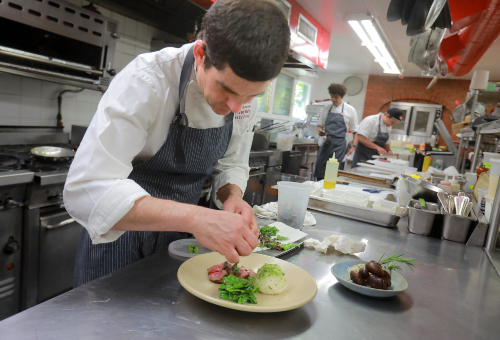 Chef Jesse Mallgren prepares Japanese Waygu beef in the kitchen at Madrona Manor in Healdsburg. (photo by John Burgess/The Press Democrat)