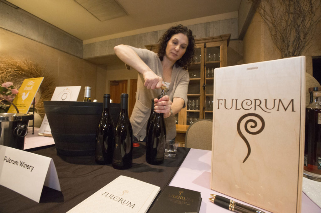 Anne Berke pours for Fulcrum Wines, who have anew tasting room location in Vine Alley. LocalFest, a 'fair' for new businesses in the Valley, sponsored by the Chamber of Commerce, this year included various nonprofits looking for volunteers and donations. (Photo by Robbi Pengelly/Index-Tribune)