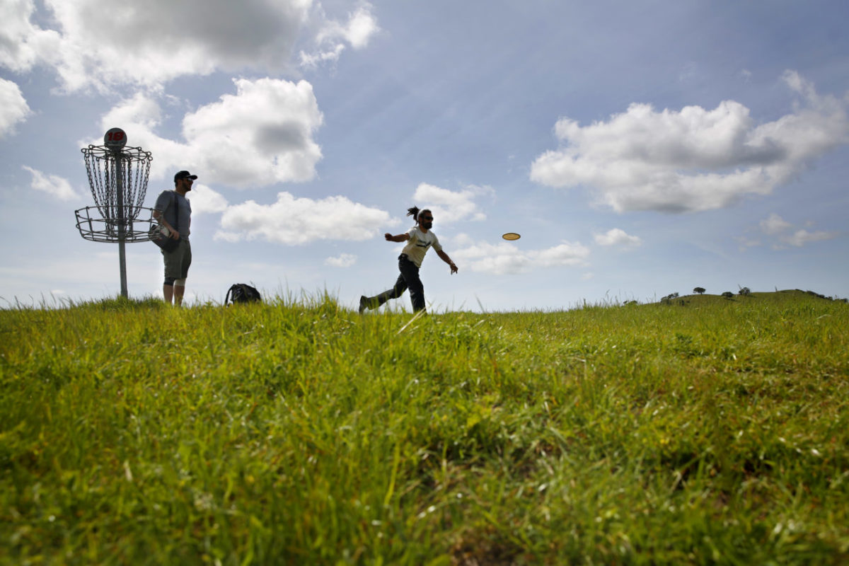 Alex Frazer tees off while playing disc golf with his friend Shane Tracy at Crane Creek Regional Park on Monday, March 23, 2015 in Rohnert Park, California . (BETH SCHLANKER/ The Press Democrat)