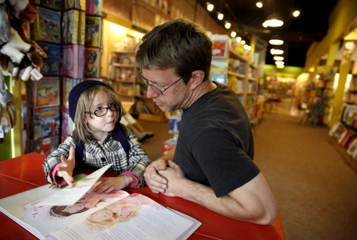 BEST OF - Adelaide Hill, 5, and her dad, Luke Gosselin read together in the children's section at Copperfield's Books in Petaluma, California on Monday, June 24, 2013. (BETH SCHLANKER/ The Press Democrat)