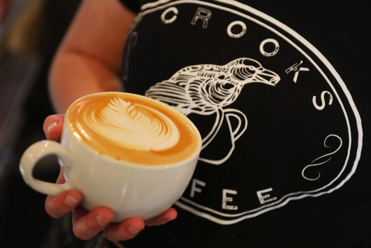 Crooks Coffee barista serves up a latte for a customer in Santa Rosa on Thursday, November 29, 2018. (Christopher Chung/ The Press Democrat)