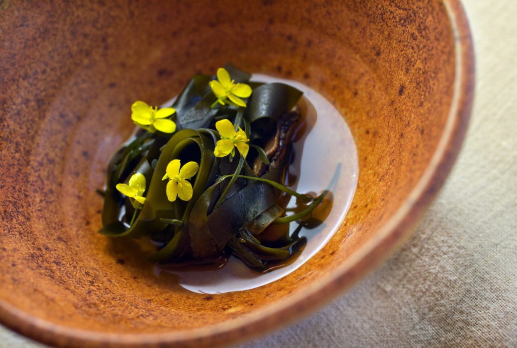 Grilled abalone, field mustard and seaweeds from our cove from chef Matt Kammerer at the Harbor House in Elk along the Mendocino coast. (photo by John Burgess/The Press Democrat)