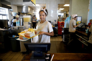 Amy's employee Karina Berry delivers food to the tables at Amy's Drive Thru on Wednesday, June 29, 2016 in Rohnert Park, California . (BETH SCHLANKER/ The Press Democrat)