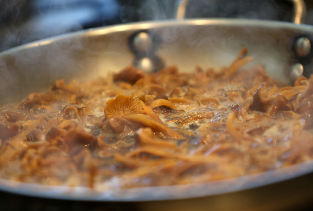Yellow foot mushrooms simmer in a pan at Relish Culinary Adventures in Healdsburg, on Sunday, January 20, 2013. (Christopher Chung/ The Press Democrat)
