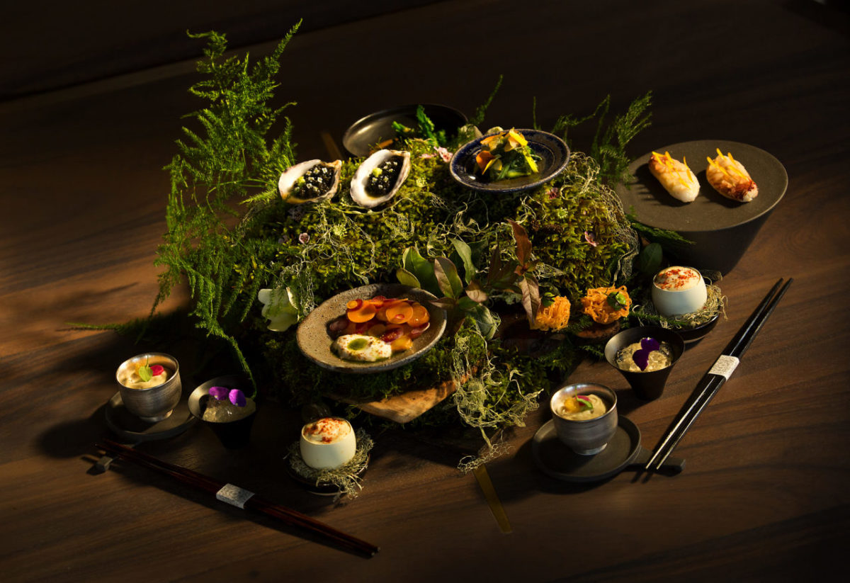 Guests are greeted with an array of dishes presented on a bed of wood, moss and ferns at SingleThread Farms Restaurant in Healdsburg. (John Burgess/The Press Democrat)