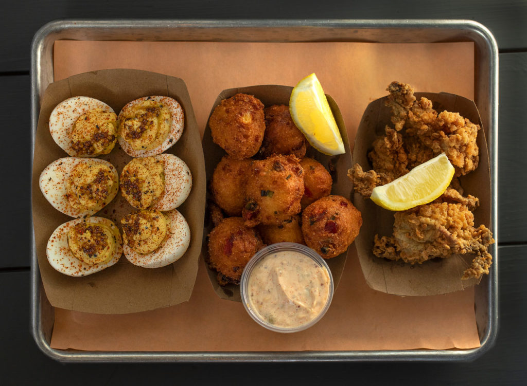 Snacks and Starters include, from left, deviled eggs, hush puppies, and fried oysters from Boxcar Fried Chicken & Biscuits in on Hwy 12 near Sonoma. (photo by John Burgess/The Press Democrat)