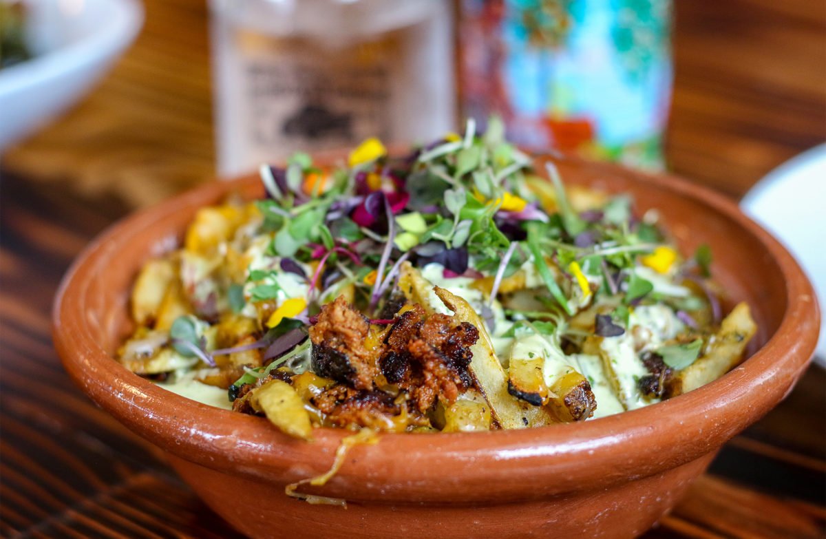 Papas Fritas with Thistle Meats Argentine-style chorizo, handcut Kennebec potatoes, cilantro aioli, roasted poblano salsa, cheddar and jack cheese at Butcher Crown Roadhouse in Petaluma. Heather Irwin/PD