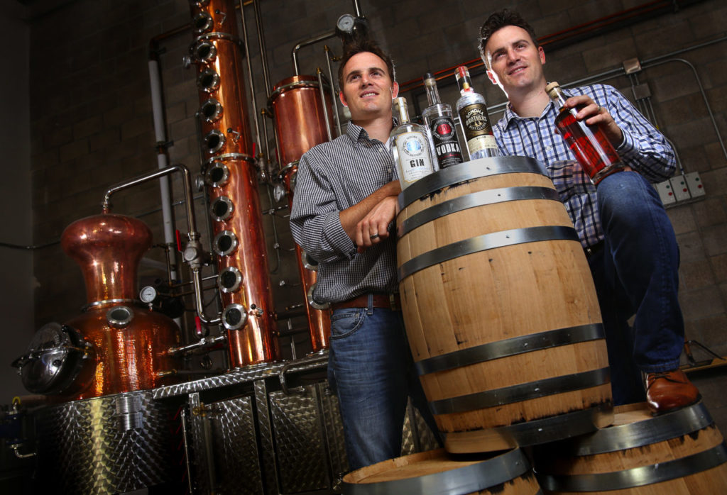 Twin brothers Chris, left, and Brandon Matthies own and operate Sonoma Brothers Distilling, in Windsor. The brothers produce their own line of gin, vodka and whiskey in their handmade Arnold Holstein copper pot still. (Christopher Chung/ The Press Democrat)