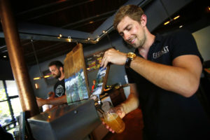 Fraser Ross pours a beer for the Friday crowd at Fogbelt Brewing Company in Santa Rosa. (Conner Jay/The Press Democrat)