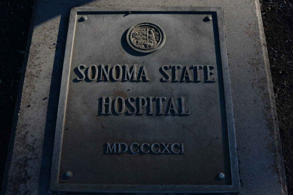 An old metal sign at the entrance to the Sonoma Development Center, once known as the Sonoma State Hospital, with the Roman numeral date 1891; the year the mental hospital first opened its doors in the town of Eldridge, California. June 29, 2015. (Photo: Erik Castro/for Sonoma Magazine)