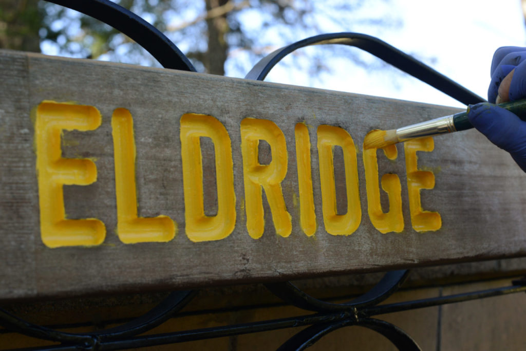 A sign being touched up by a painter as you enter the town of Eldridge, California; the home of the Sonoma Development Center. June 23, 2015. (Photo: Erik Castro/for Sonoma Magazine)