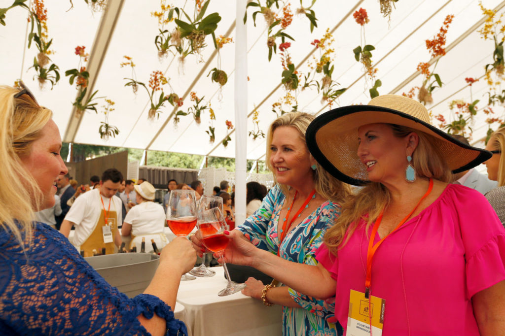 Lisa Covey of Yountville, left, toasts sisters Kimberly and Courtney Bringgold, both of Newport Beach, during Auction Napa Valley at Meadowood Resort in St. Helena, California on Saturday, June 3, 2017. (Alvin Jornada / The Press Democrat)