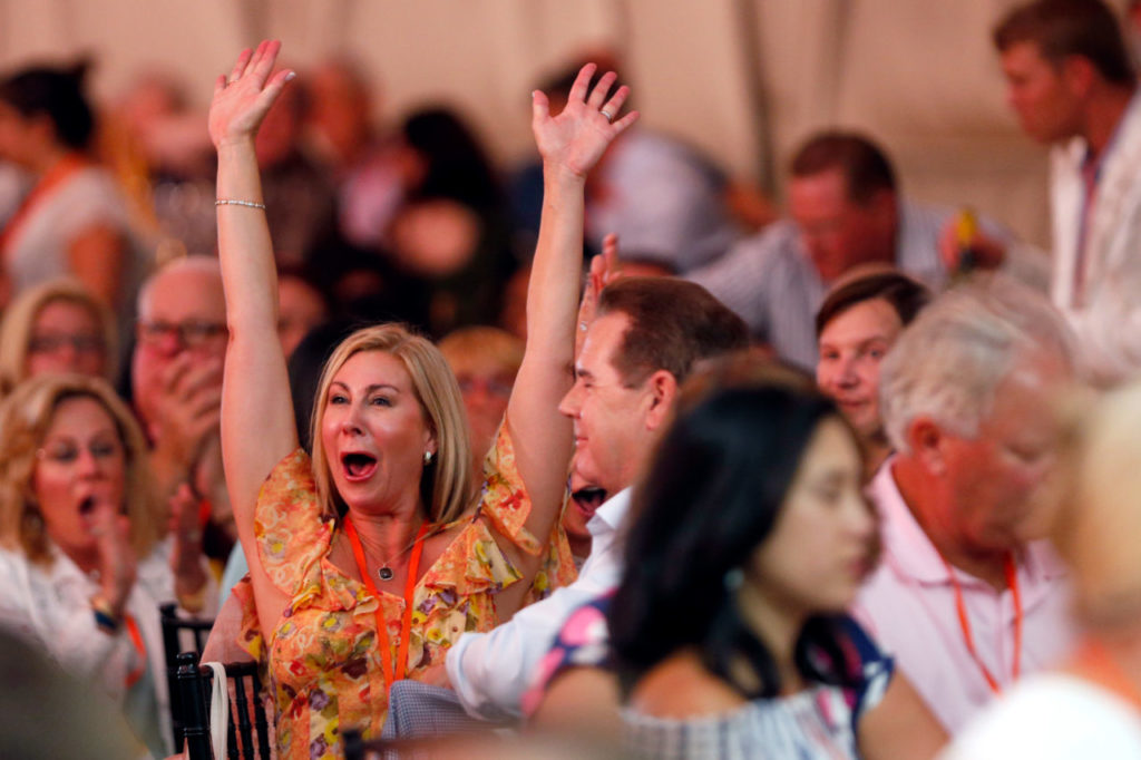 A bidder reacts in excitement after winning an auction lot with a highlight 24-day, 10 destination around the world trip in a private jet along with a variety of Napa Valley Wines during Auction Napa Valley at Meadowood Resort in St. Helena, California on Saturday, June 3, 2017. (Alvin Jornada / The Press Democrat)