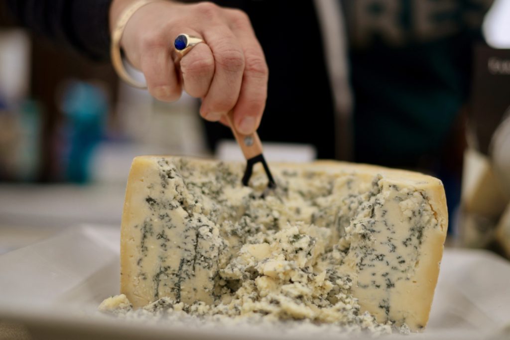 Nicole Ryan digging into Point Reyes Farmstead Cheese Company's Bay Blue during the 11th annual California Artisan Cheese Festival held at the Sheraton Sonoma County in Petaluma Sunday. March 26, 2017. (Photo: Erik Castro/for The Press Democrat)