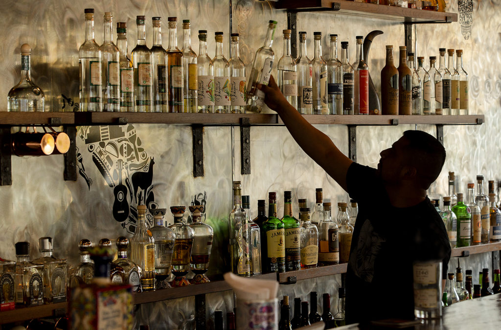 Bartender Al Vasquez serves up a variety of mezcal and tequilas at El Gallo Negro Bar and Mezcaleria in Windsor. (photo by John Burgess/The Press Democrat)