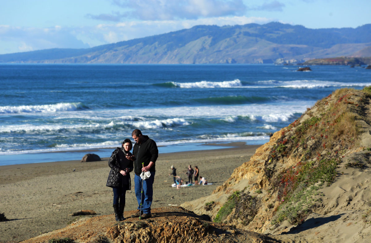 Tarik and Izabela Kanaana pose for a picture above Salmon Creek State Beach in Bodega Bay on Thursday. (JOHN BURGESS / The Press Democrat)