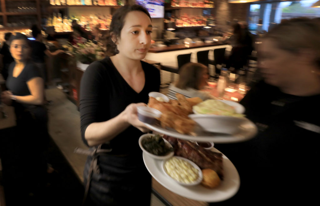 During a soft opening for Sweet T's in Windsor, Monday, March 4, 2019 server Hayley Louzao delivers food to customers. Sweet T's was destroyed during the Tubb's fire as it roared over Fountaingrove and in to Santa Rosa. (Kent Porter / The Press Democrat) 2018