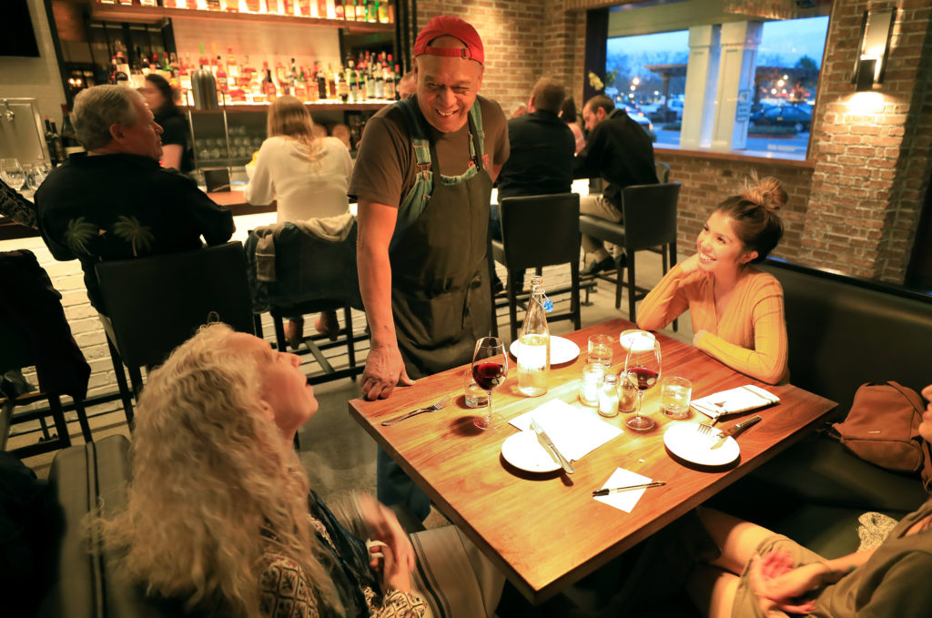 Sweet T's George Ah Chin talks with customers, Monday, March 4, 2019 during a soft opening of the restaurant's new location in Windsor. Sweet T's was destroyed during the Tubb's fire as it roared over Fountaingrove and in to Santa Rosa. (Kent Porter / The Press Democrat) 2018