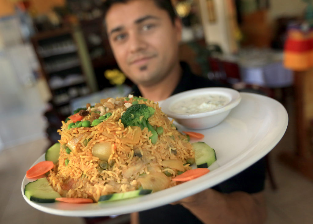 Chef manager Bishnu Pandey of Himalayan Restaurant of Windsor display's a Vegetable Himalayan Biryani. (Kent Porter / The Press Democrat) 