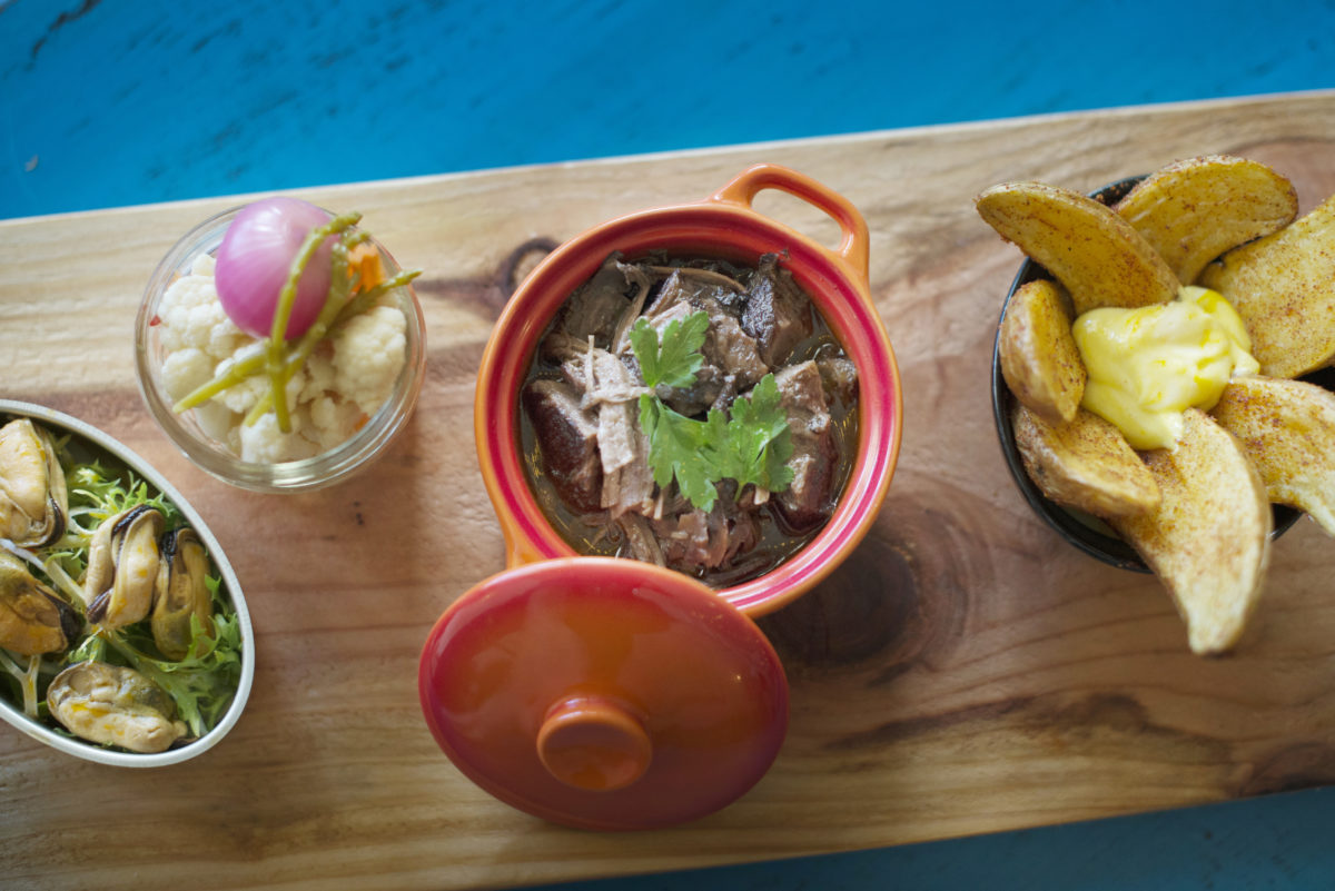 From front to back, marinated mussels, marinated vegetables, goat stew with fingerling potatoes and fried piri piri potatoes at Tasca Tasca Portuguese Tapas Restaurant & Wine Bar in Sonoma. April 22, 2016. (Erik Castro/for The Press Democrat)