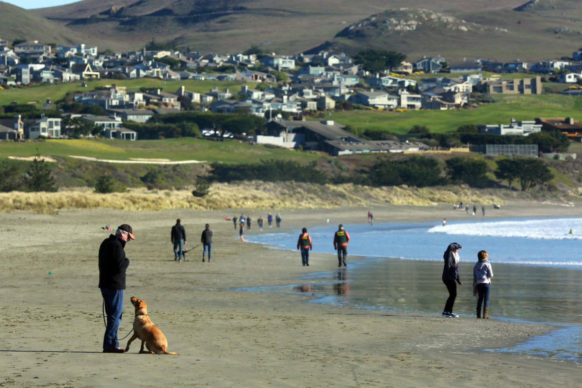 People enjoy a sunny walk at Doran Beach in Bodega Bay on Thursday. (JOHN BURGESS / The Press Democrat)