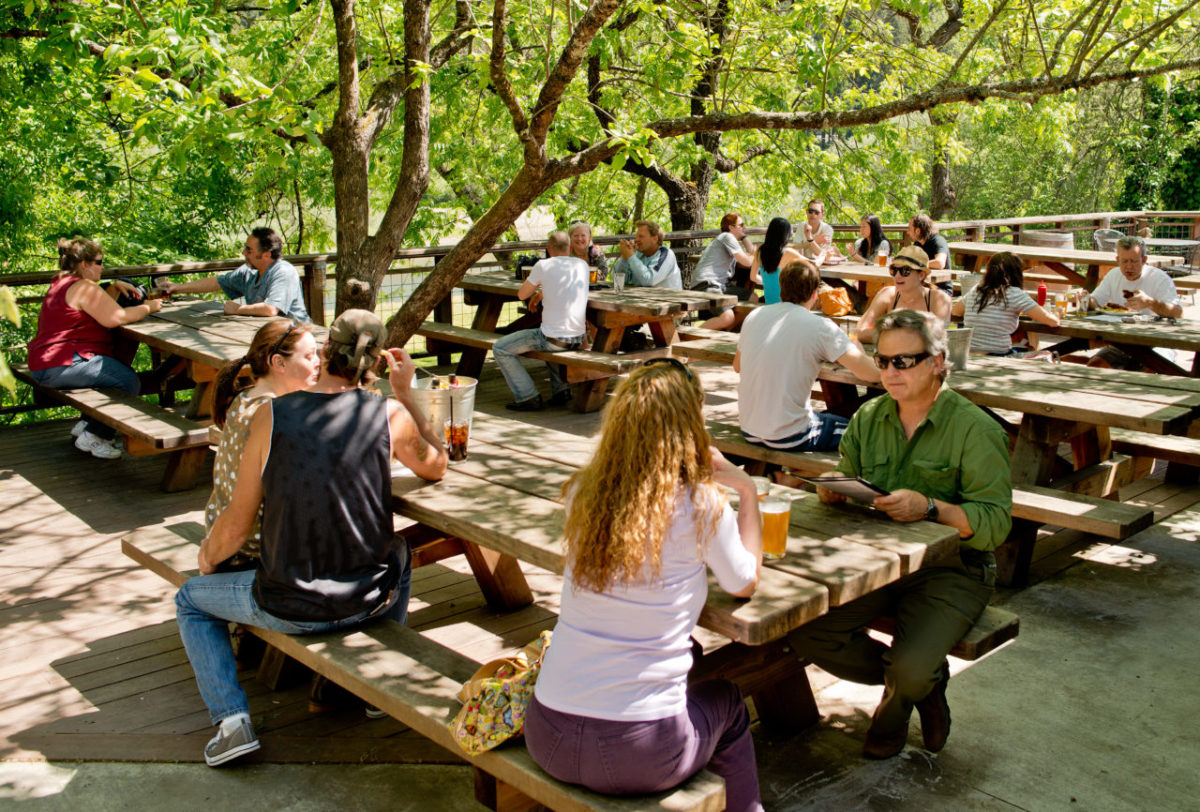 Guests enjoying cold drinks on the patio overlooking the Russian River at Stumptown Brewery in Guerneville, on April 20, 2013. (Alvin Jornada / The Press Democrat)