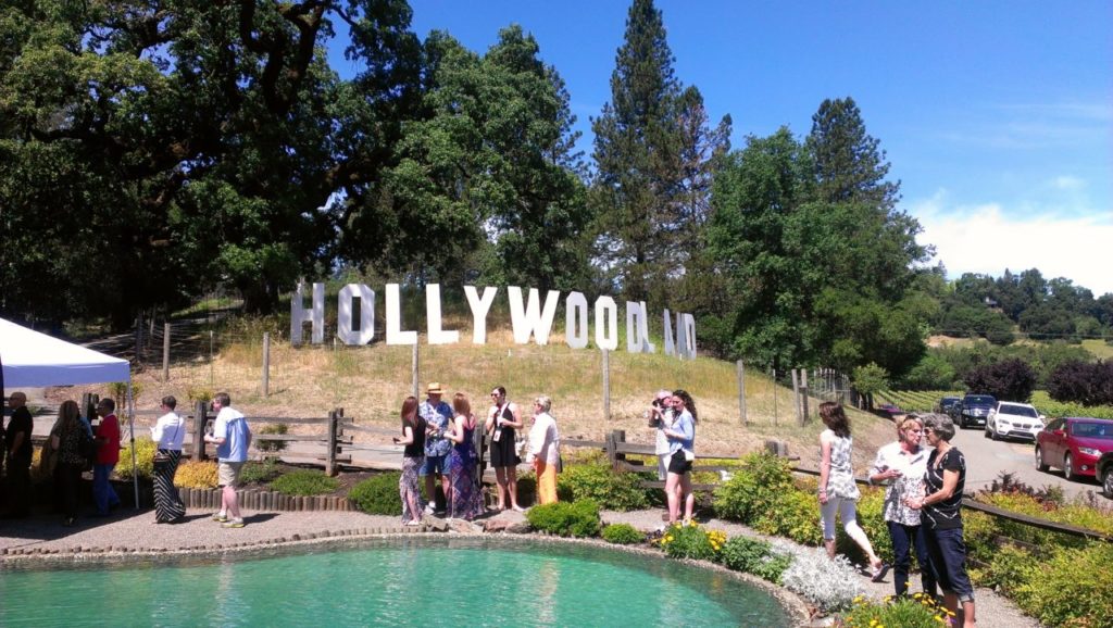 Mill Creek Vineyards: Another winery that defines Passport, the Kreck family provide seated dining with tableside service of delicious small bites from the excellent Peloton Catering. Past themes have been flashy and fun, from a Prohibition era speakeasy to a 1940s Vegas vacation. This time around, the family-owned winery is sharing more of their personal stories, focusing on family, with decades of photos from the owners and the staff. (Photo Credit: Chelsea Kurnick)