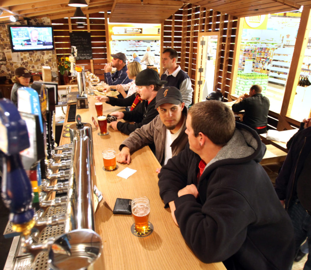 10/24/2010: E1: PC: Mark Walker, from right and Robert Wachter both from Windsor have a beer at the Tap Room inside the new Whole Foods in Coddingtown Mall, Oct. 22, 2010. The two wanted to see what the pub was like, "The got good ales," Wachter said.