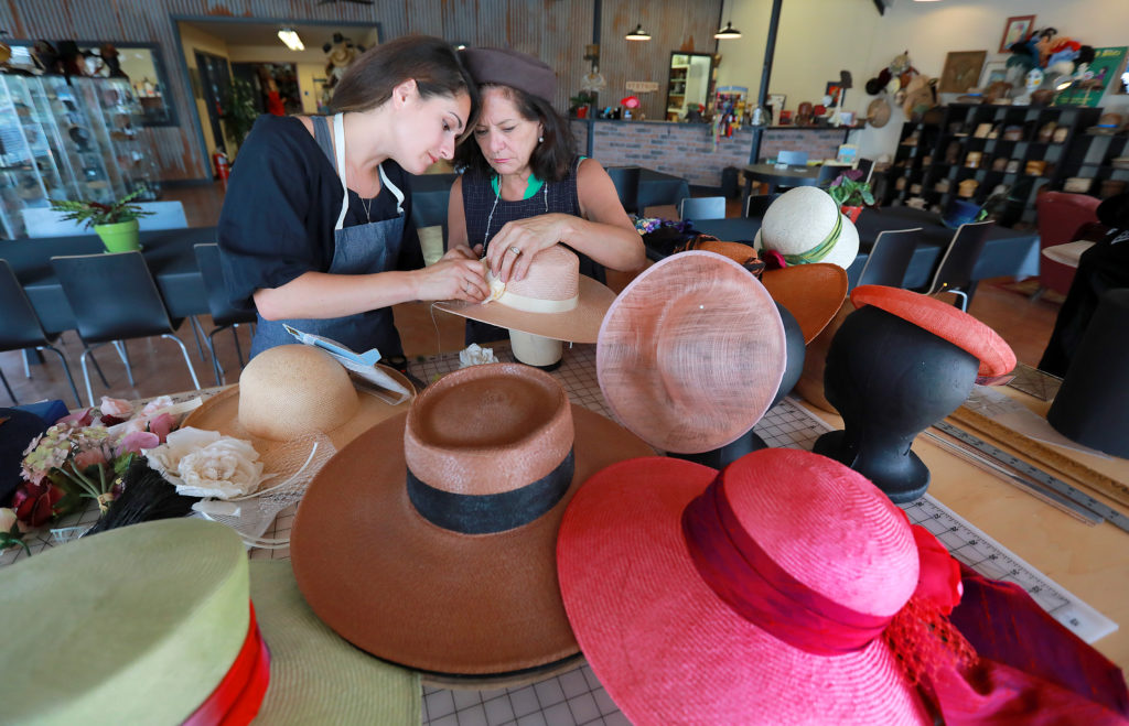 Jennifer, right, and her daughter Elizabeth Webley find the right combination for a hat band at The Hattery in Santa Rosa. (photo by John Burgess/The Press Democrat)