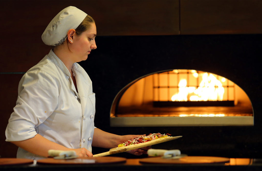 Moon Levin works the pizza oven during lunch at the SRJC Culinary Cafe. (JOHN BURGESS / The Press Democrat)