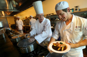 Student Beau Behler, right, shows SRJC Culinary Director Michael Salinger his plating of a duck entree in the kitchen at the SRJC Culinary Cafe. (John Burgess/The Press Democrat)