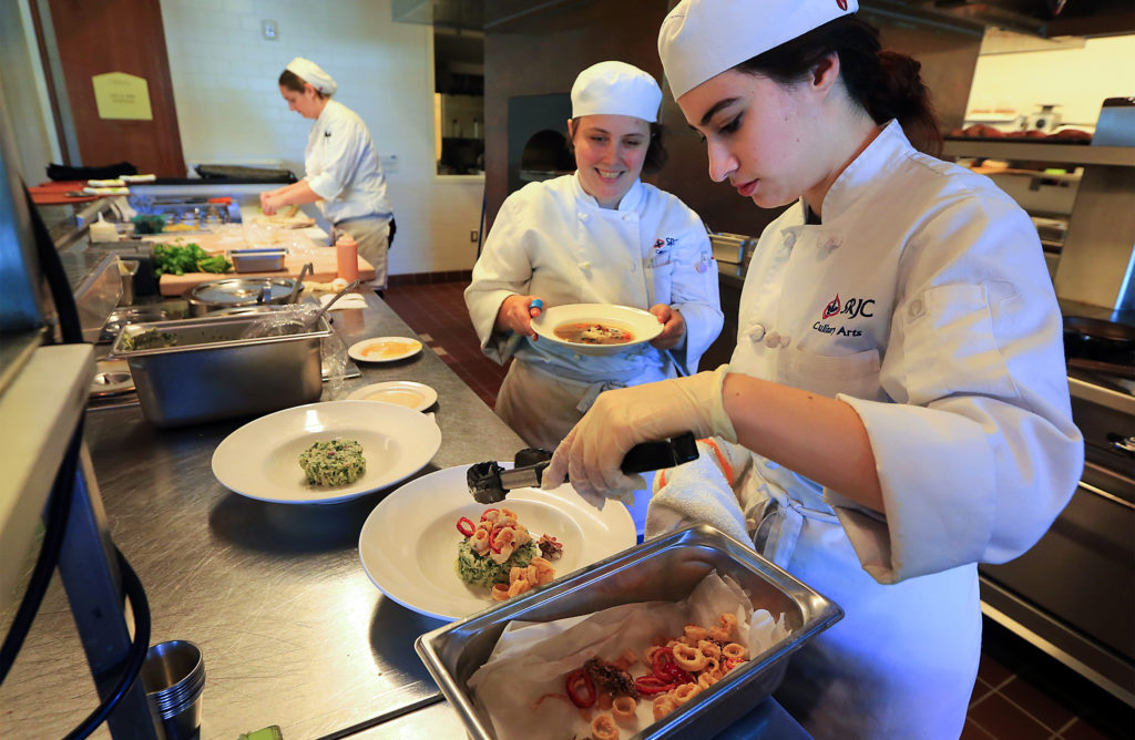 Devin Green, right, Cali Willis and Moon Levine plate lunch orders at SRJC's Culinary Cafe. (JOHN BURGESS / The Press Democrat)