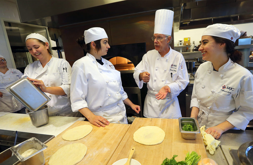 SRJC Culinary Director Michael Salinger, second from right, talks with students about the day's specialty pizza's at the SRJC's Culinary Cafe. (JOHN BURGESS / The Press Democrat)