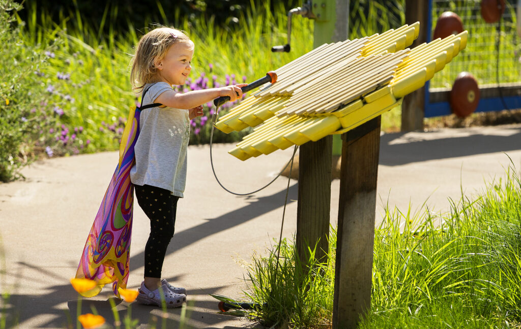 Serena Wilson, 2, delights at the music for a a xylophone at the Sonoma County Children's Museum on Friday, April 16, 2021. The museum is open for members for the first time in 53 weeks. (Photo by John Burgess/The Press Democrat)