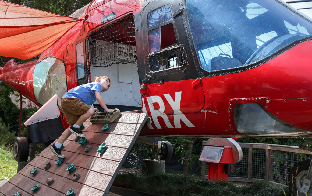 Ryeson Bull clings into a helicopter play structure at the Children's Museum of Sonoma County in Santa Rosa. (Christopher Chung/The Press Democrat)