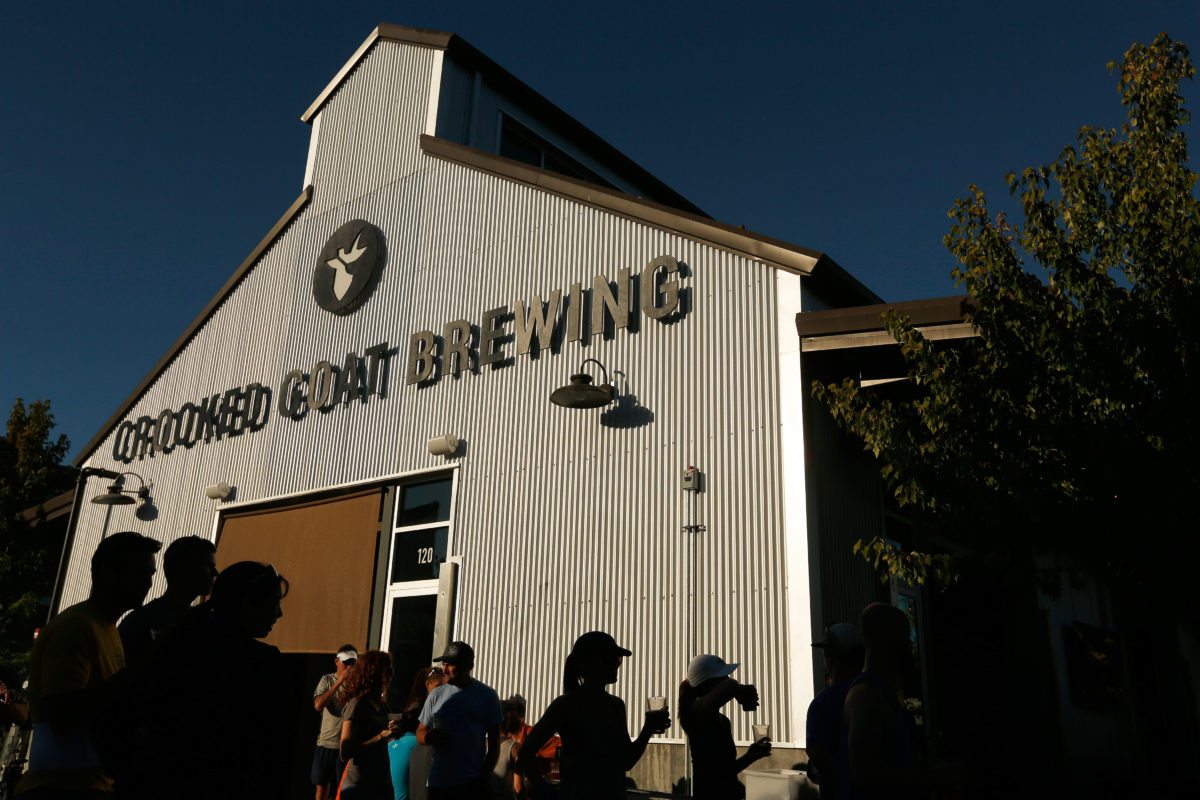 Participants in a fun run enjoy drinks outside Crooked Goat Brewing after their run, at the Barlow in Sebastopol, California, on Wednesday, July 11, 2018. (Alvin Jornada / The Press Democrat)