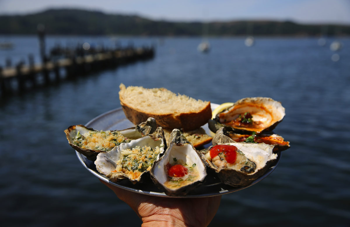 A sampler plate of Rockefeller, left, barbecued, and Kilpatrick oysters at The Marshall Store. (Christopher Chung/ The Press Democrat)
