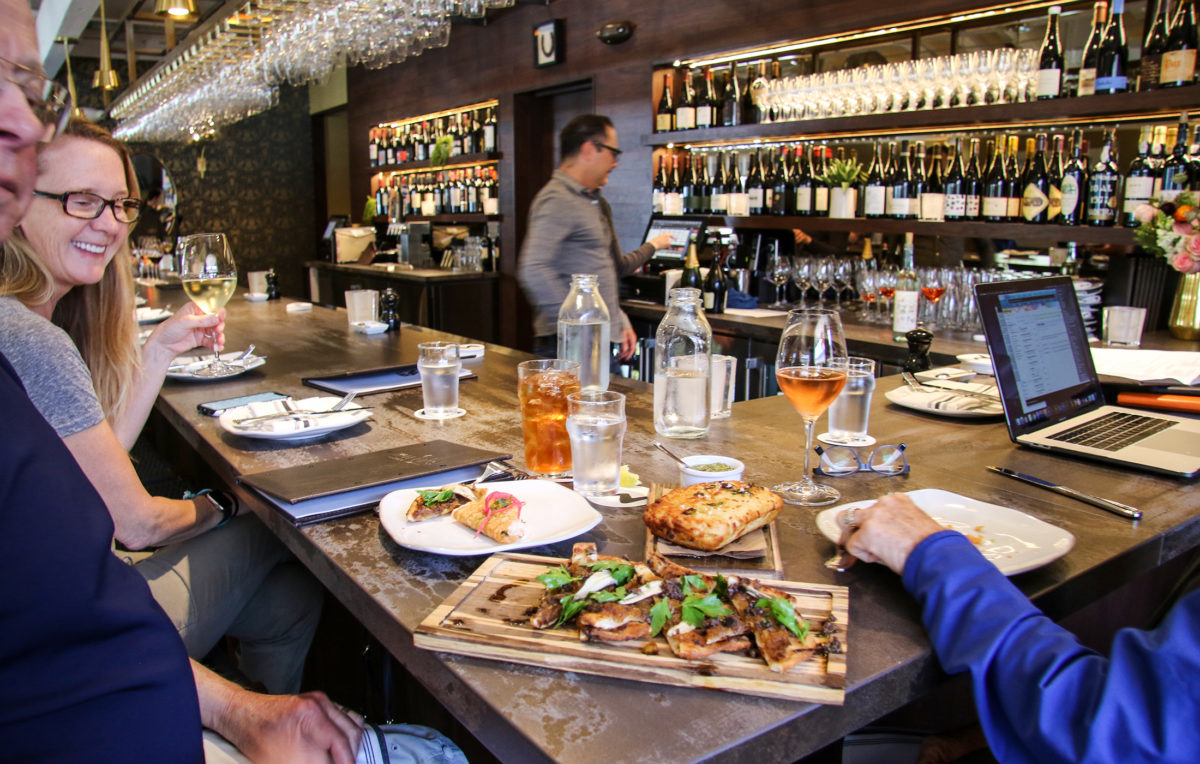 Guests at Willi's Wine Bar in Santa Rosa on opening day of the new location after the Tubbs fire destroyed the original location in October 2017. (Heather Irwin / Sonoma Magazine)