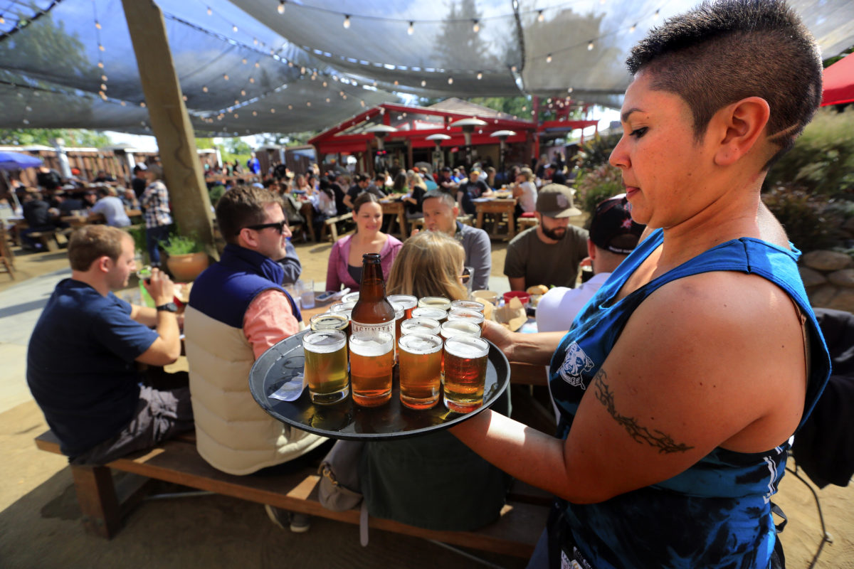 Maryana Bustamonte serves up a round of samplers at the popular Lagunitas Taproom in Petaluma. (John Burgess / Sonoma Magazine)