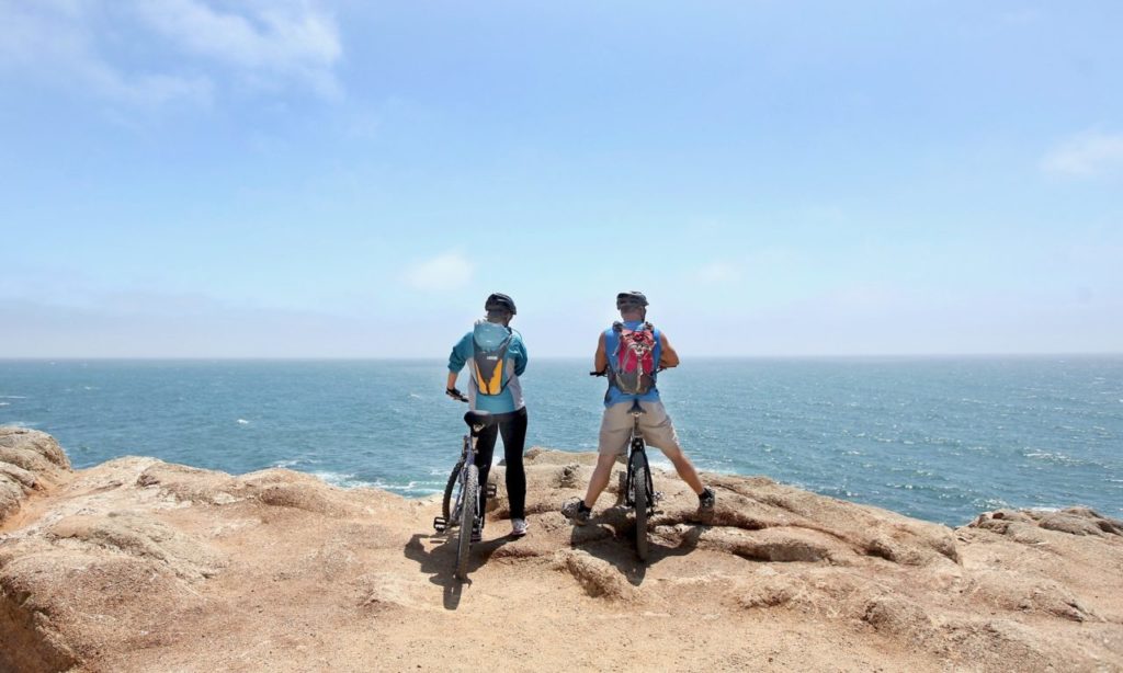 Sonoma County residents Valerie and Dave Thompson take a break from a tour of Bodega Bay as they look for whales off Bodega Head, Friday July 13, 2012. (Kent Porter / Press Democrat) 2012